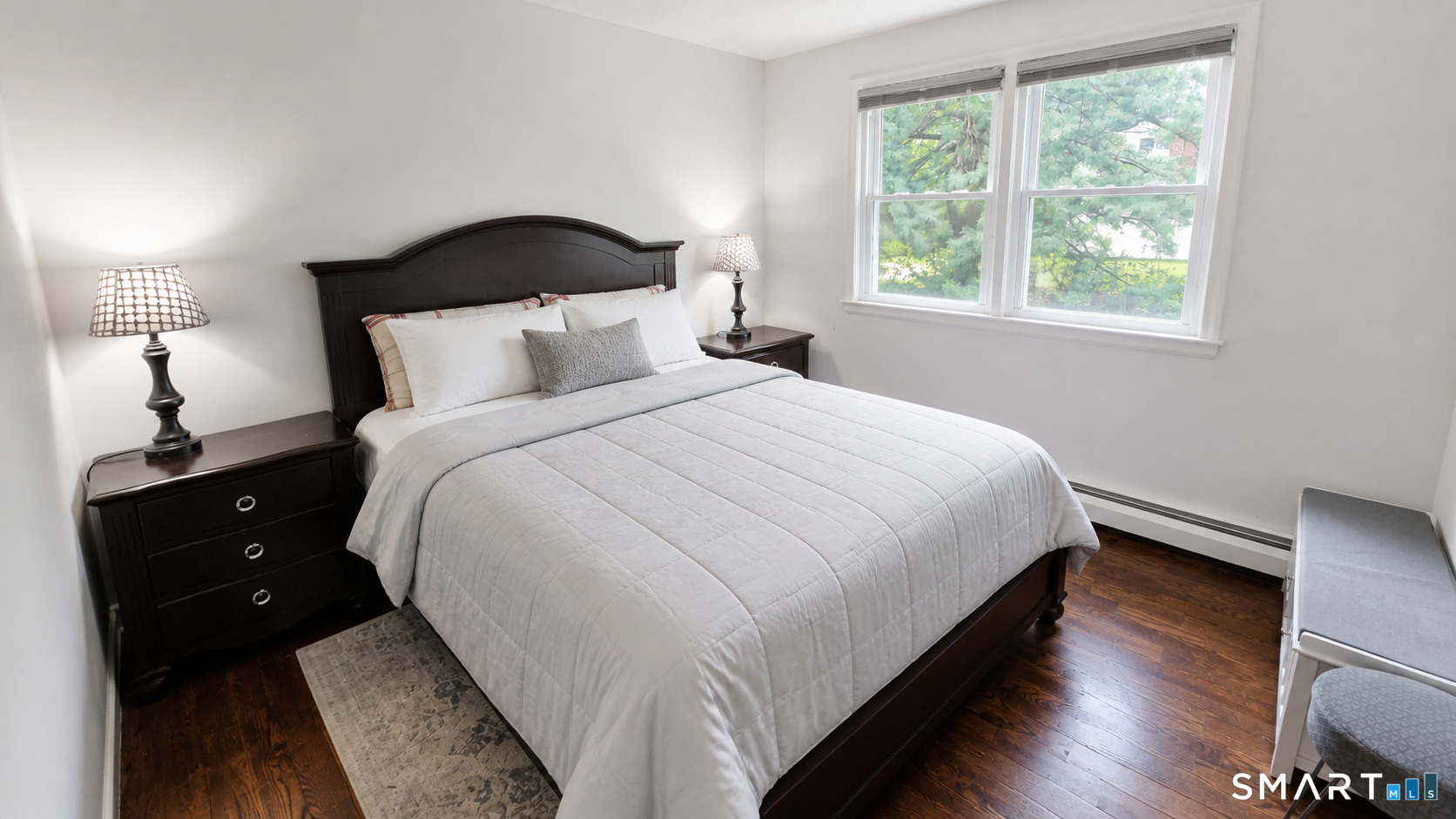 63 Pond Road Windsor, CT 06095 - Photo 12 of 17 a large bed sitting in a bedroom next to a window
