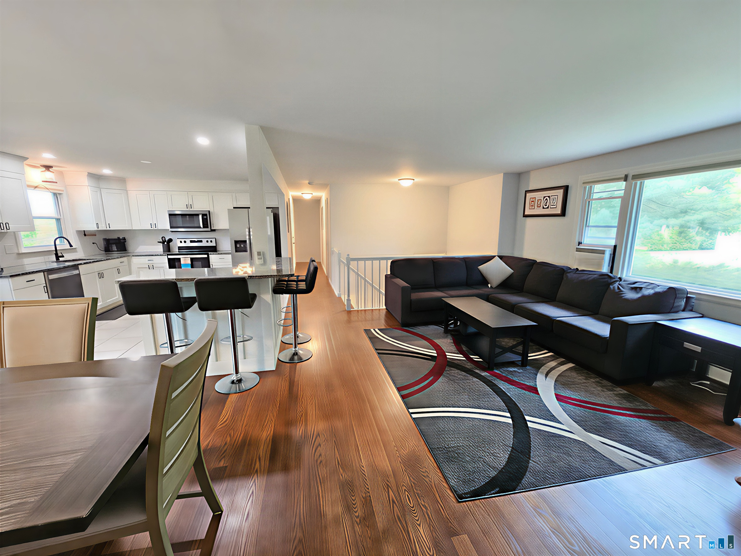 63 Pond Road Windsor, CT 06095 - Photo 3 of 17 a living room with furniture a wooden floor and a large window