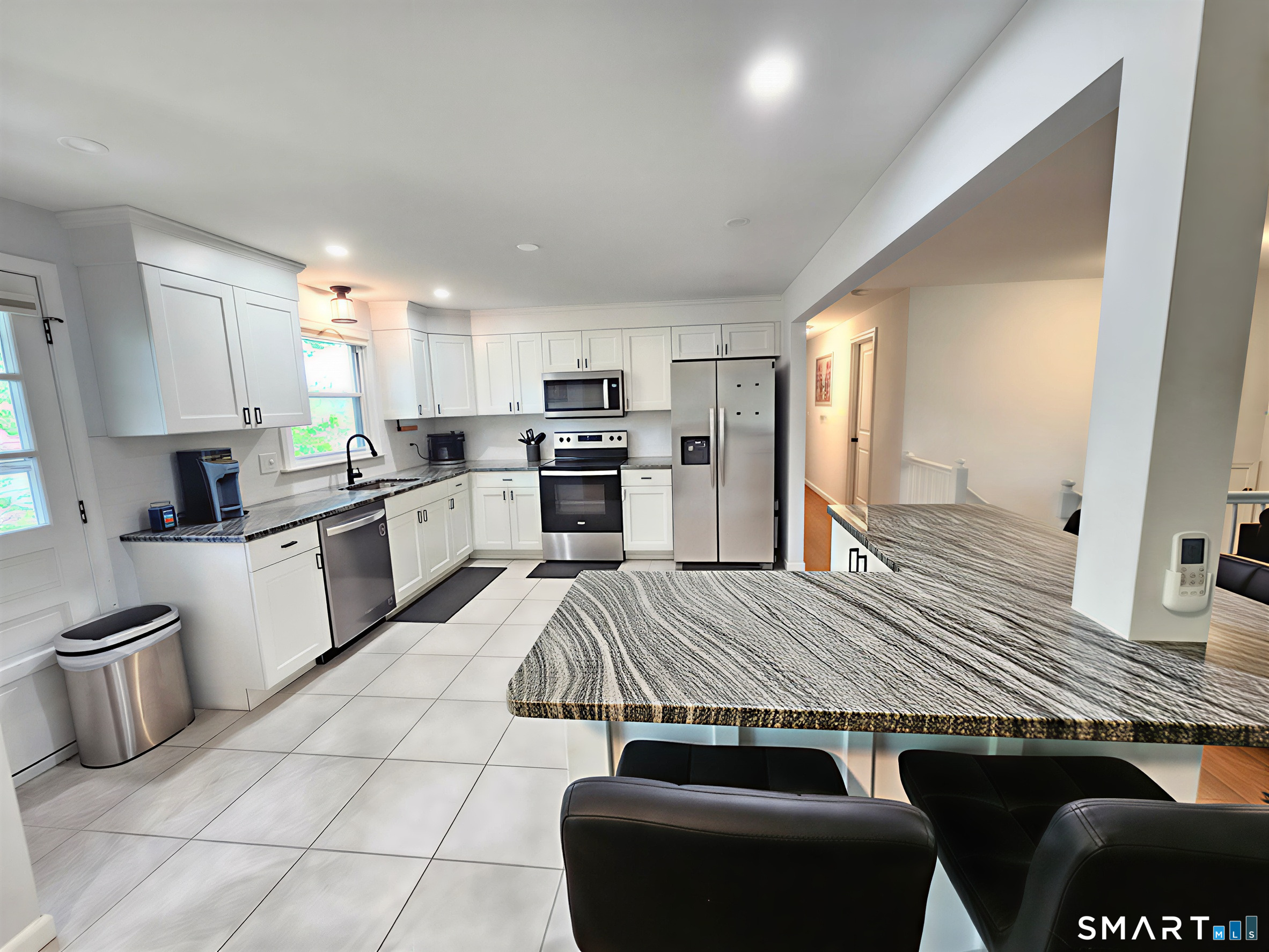 63 Pond Road Windsor, CT 06095 - Photo 6 of 17 a kitchen with stainless steel appliances granite countertop a stove a sink dishwasher and a refrigerator with wooden floor