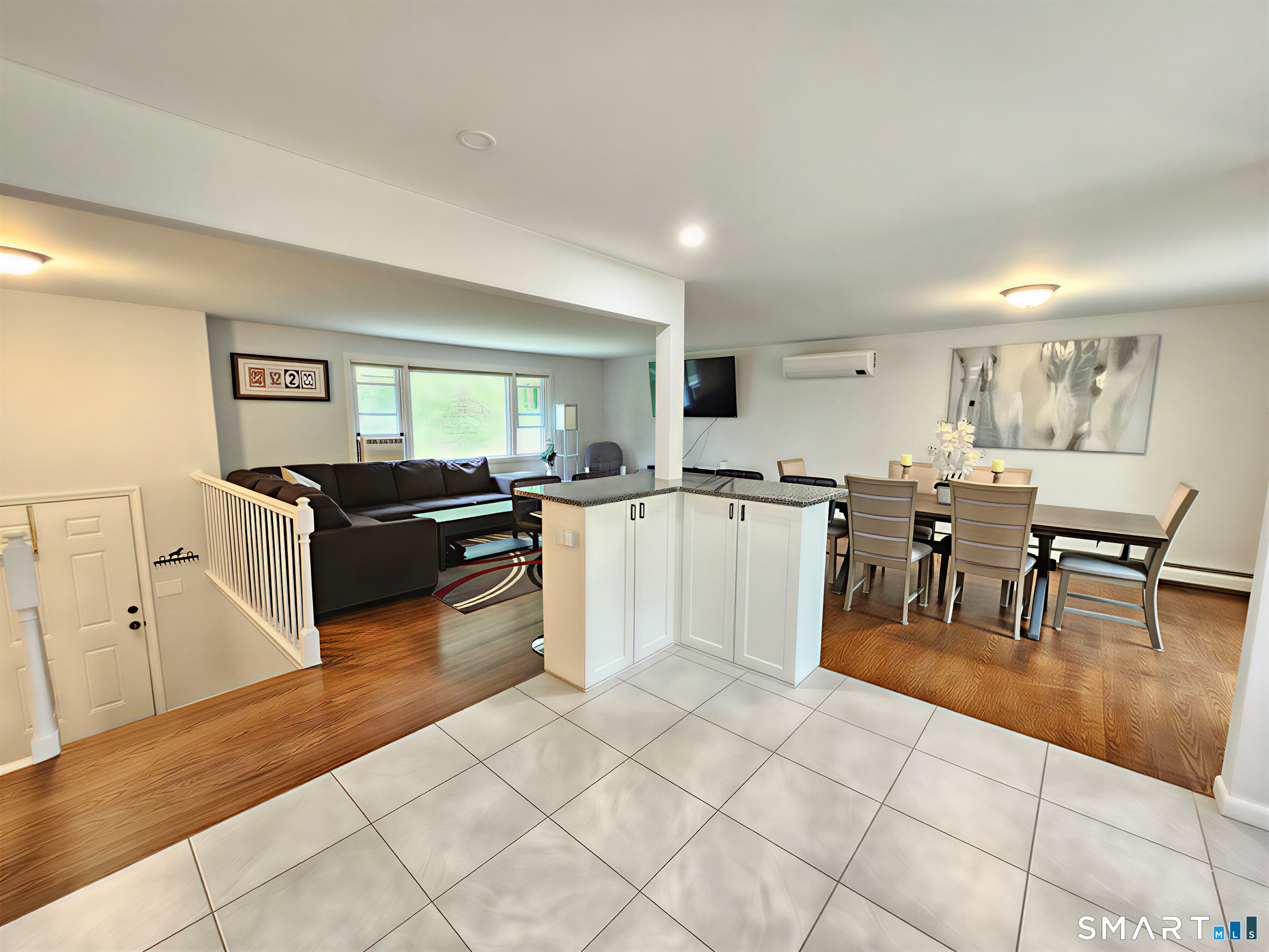 63 Pond Road Windsor, CT 06095 - Photo 8 of 17 a living room with furniture and a dining table with wooden floor