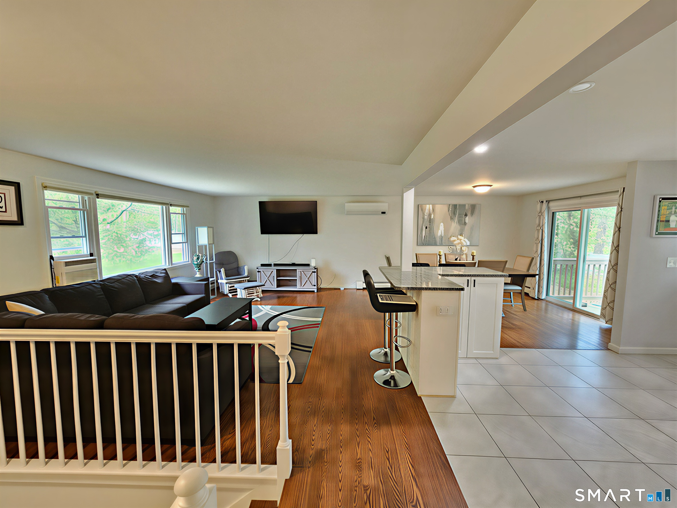 63 Pond Road Windsor, CT 06095 - Photo 9 of 17 a living room with furniture a flat screen tv and a floor to ceiling window