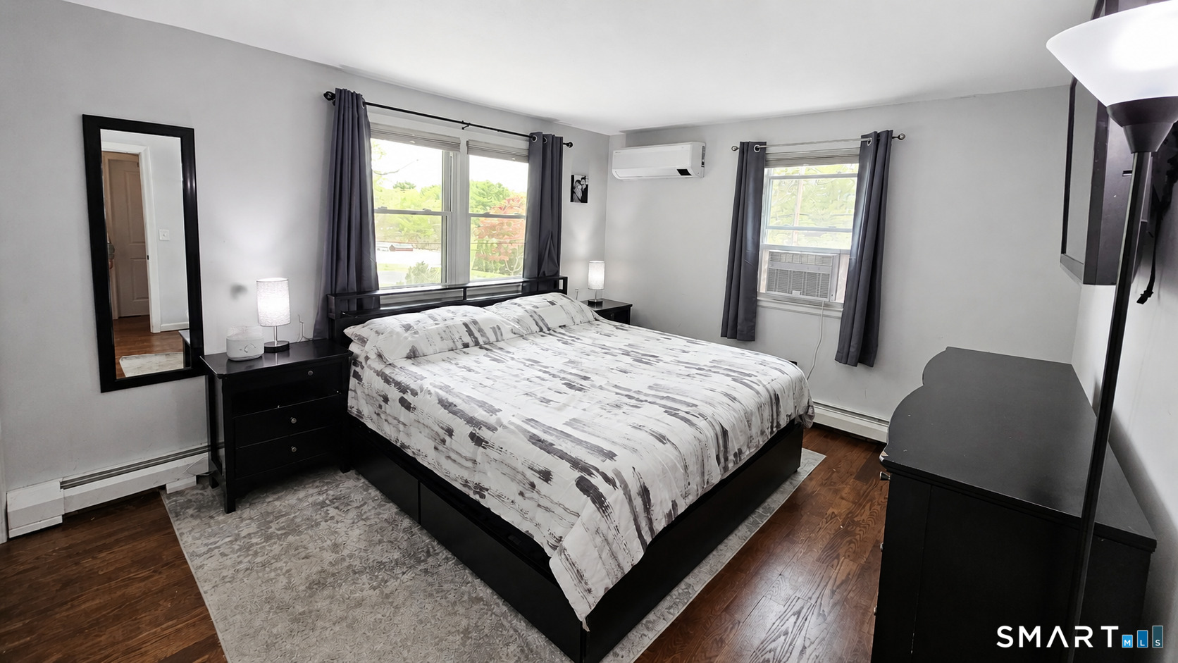 63 Pond Road Windsor, CT 06095 - Photo 10 of 17 a bedroom with a bed and wooden floor