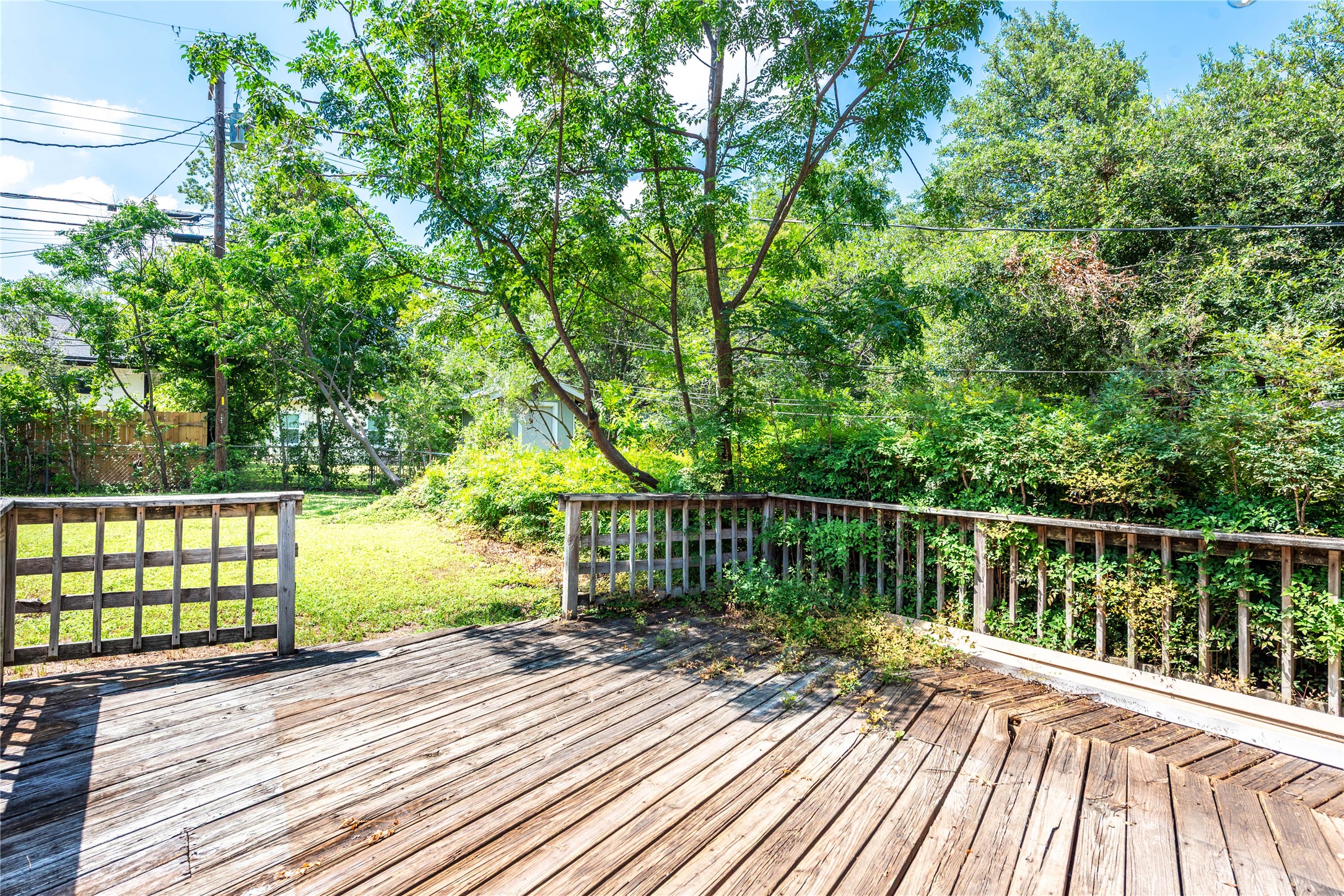 7602 Delafield Lane Austin, TX 78752 - Photo 16 of 17 A spacious wooden deck provides ample outdoor living space, overlooking a verdant, private backyard.