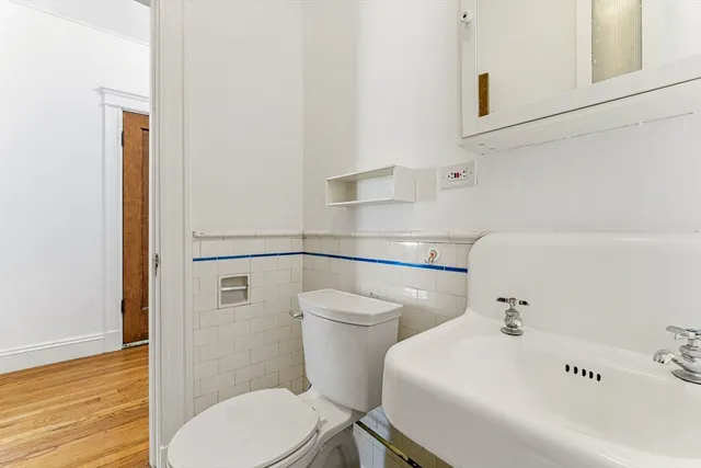 a white toilet sitting next to a bathroom sink