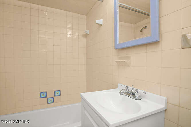 33 Sunshine Avenue Riverside, CT 06878 - Photo 13 of 26 a bathroom with a sink a vanity and a shower