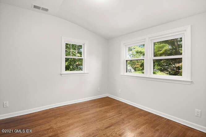 33 Sunshine Avenue Riverside, CT 06878 - Photo 15 of 26 an empty room with wooden floor and windows