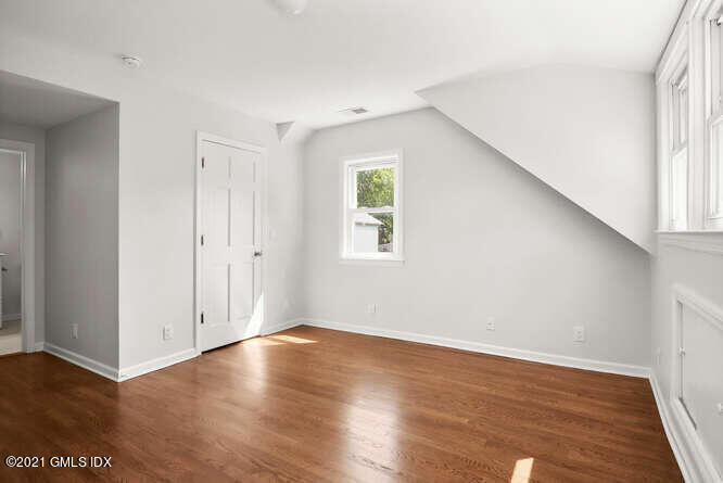 33 Sunshine Avenue Riverside, CT 06878 - Photo 18 of 26 an empty room with wooden floor and windows