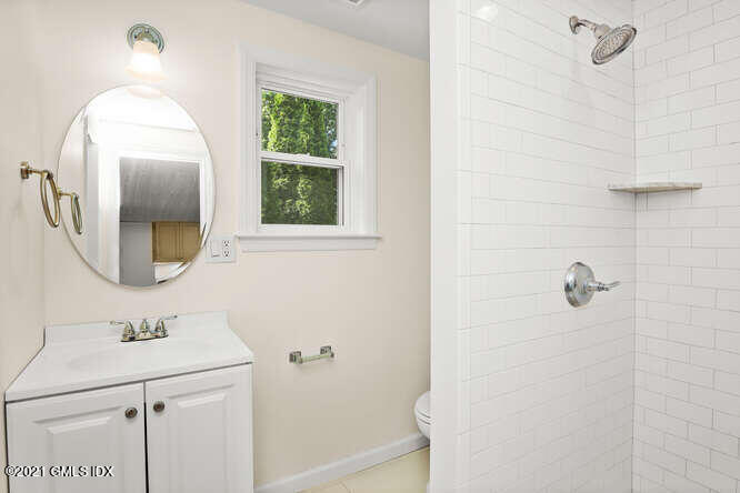 33 Sunshine Avenue Riverside, CT 06878 - Photo 19 of 26 a bathroom with a sink a mirror a vanity and a shower