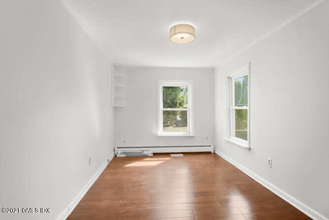 33 Sunshine Avenue Riverside, CT 06878 - Photo 21 of 26 an empty room with wooden floor and windows