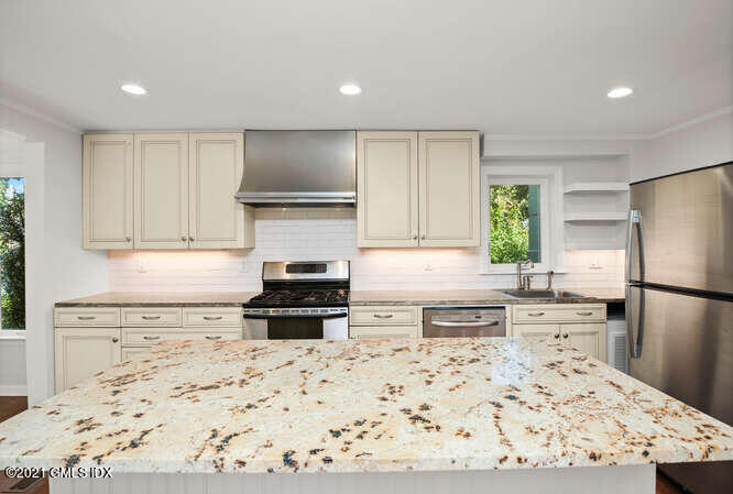 33 Sunshine Avenue Riverside, CT 06878 - Photo 4 of 26 a kitchen with a refrigerator stove and sink