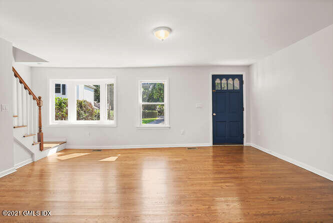 33 Sunshine Avenue Riverside, CT 06878 - Photo 7 of 26 a view of an empty room with window and wooden floor