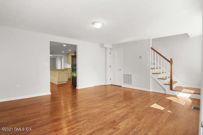 33 Sunshine Avenue Riverside, CT 06878 - Photo 9 of 26 a view of an empty room with wooden floor and a cabinet