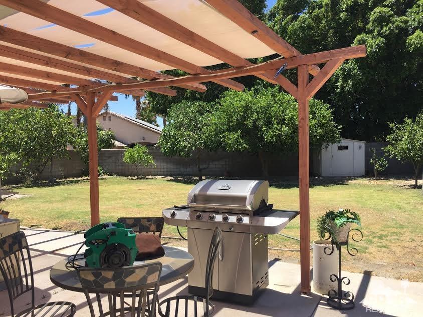 68625 Durango Road Cathedral City, CA 92234 - Photo 3 of 32 a view of a patio with lawn chairs under an umbrella