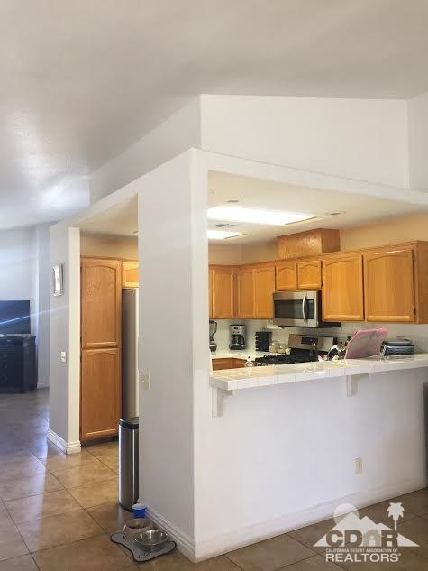 68625 Durango Road Cathedral City, CA 92234 - Photo 22 of 32 a kitchen with stainless steel appliances a sink and a refrigerator