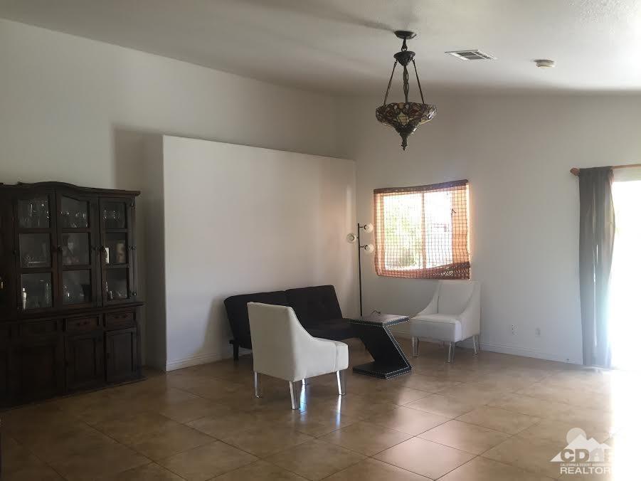 68625 Durango Road Cathedral City, CA 92234 - Photo 7 of 32 a living room with furniture a window and a chandelier