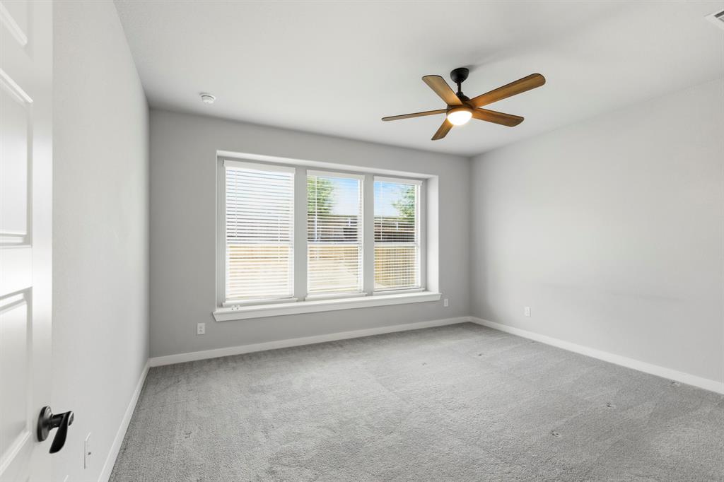 3311 Willena Road Melissa, TX 75454 - Photo 27 of 40 Room featuring light gray carpeting, neutral wall paint, and a ceiling fan with wood-finish blades