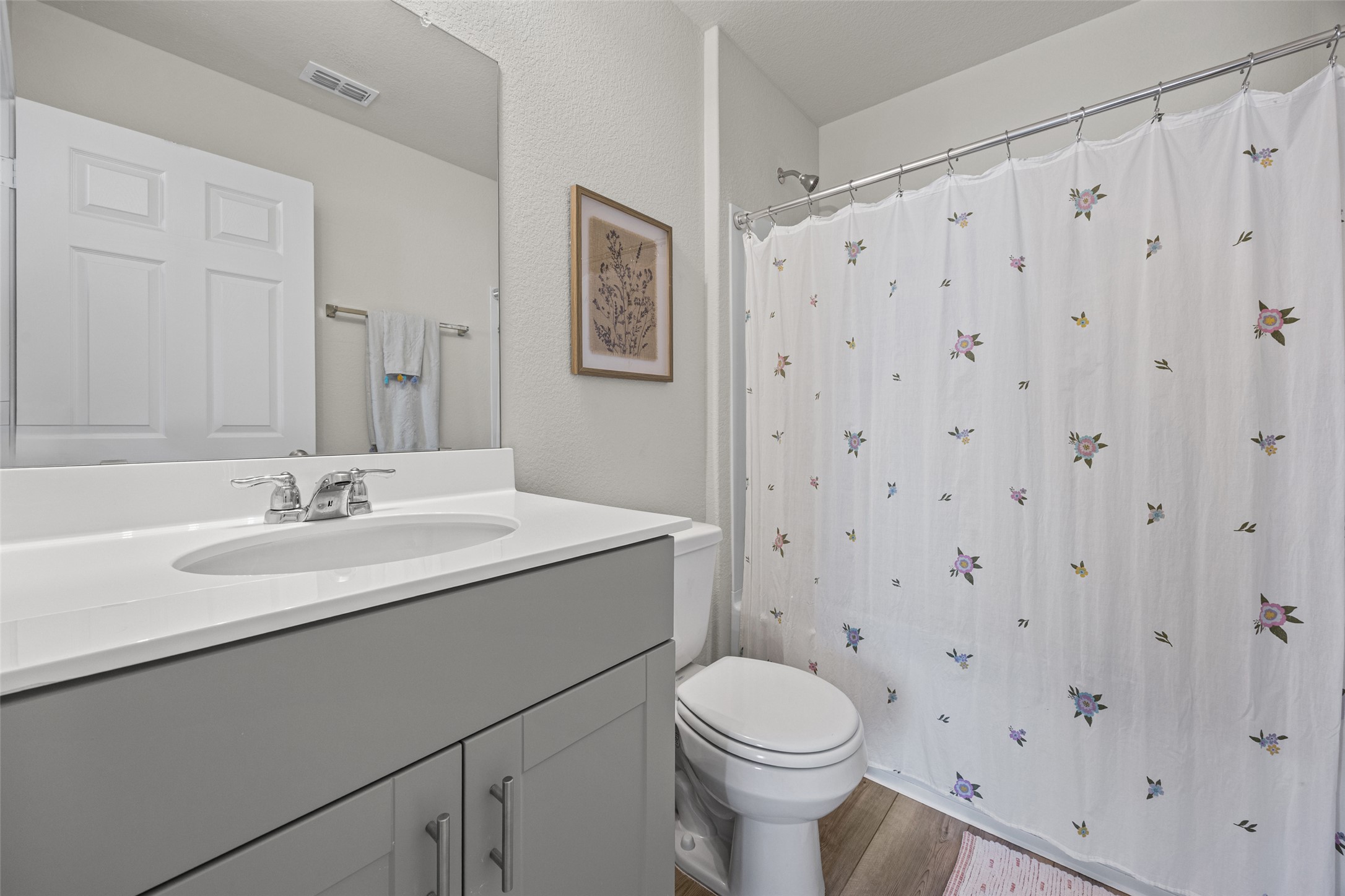 208 Orange Road Buda, TX 78610 - Photo 18 of 31 A well-appointed bathroom with a spacious vanity, sleek fixtures, and a shower.