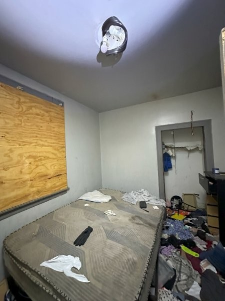 7119 South Emerald Avenue Chicago, IL 60621 - Photo 17 of 50 a bedroom with a bed and a window