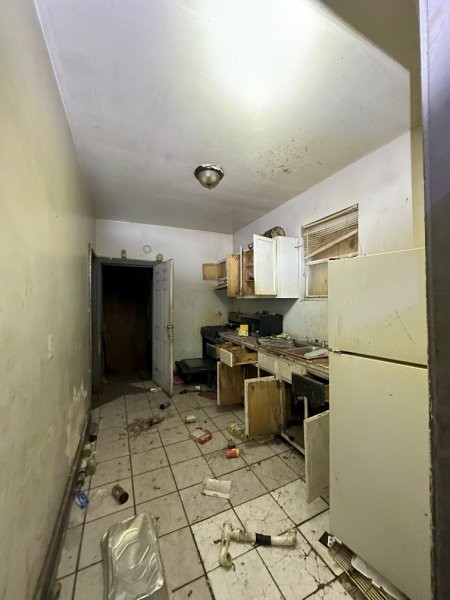 7119 South Emerald Avenue Chicago, IL 60621 - Photo 19 of 50 a kitchen with stainless steel appliances granite countertop a stove a sink and a refrigerator