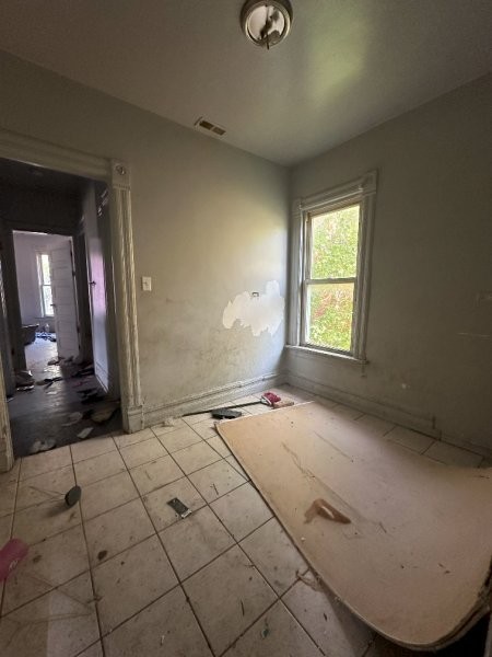 7119 South Emerald Avenue Chicago, IL 60621 - Photo 37 of 50 an empty room with a fireplace and windows