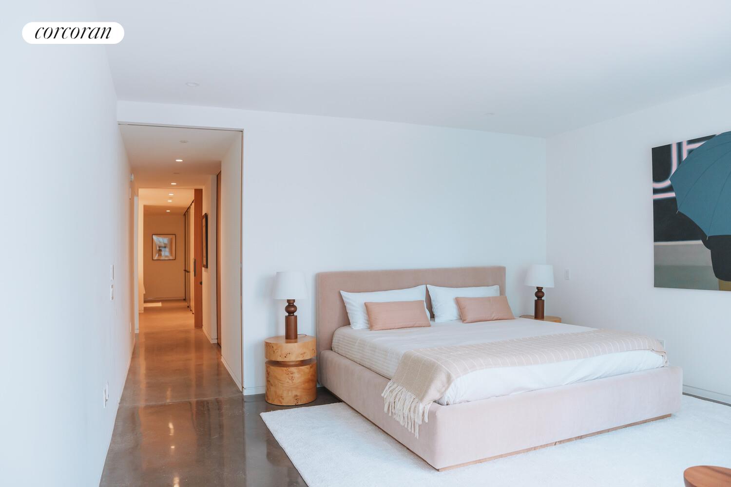 100 East 53rd Street, Unit 9C Manhattan, NY 10022 - Photo 9 of 26 a bedroom with a large bed and a night stand