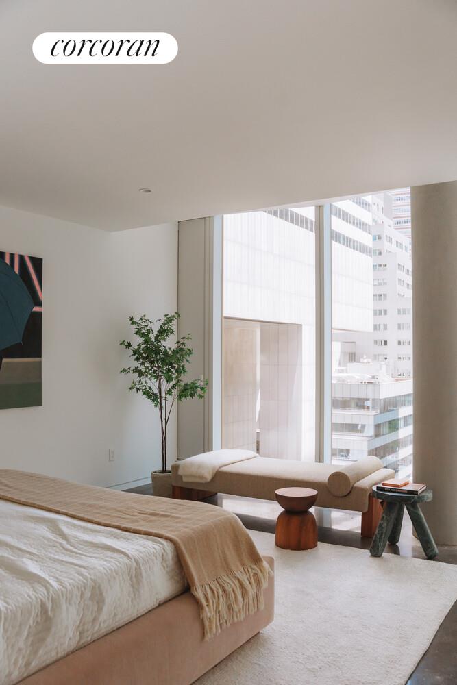 100 East 53rd Street, Unit 9C Manhattan, NY 10022 - Photo 10 of 26 a bedroom with bed and a window