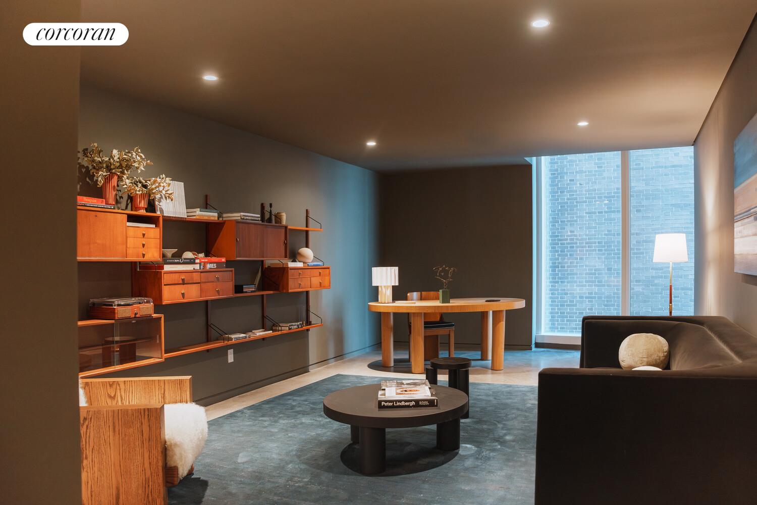 100 East 53rd Street, Unit 9C Manhattan, NY 10022 - Photo 11 of 26 a living room with furniture a rug and a fireplace