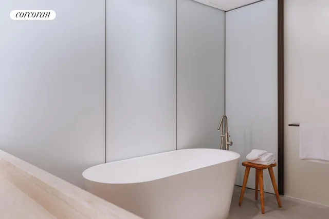 a bathroom with a bathtub and a table