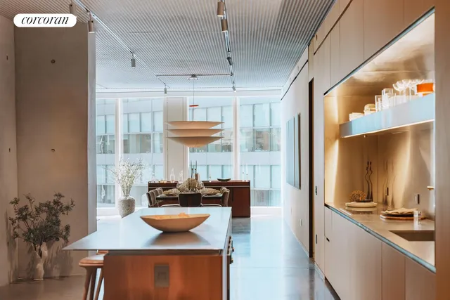 a kitchen with stainless steel appliances kitchen island granite countertop a sink and a refrigerator