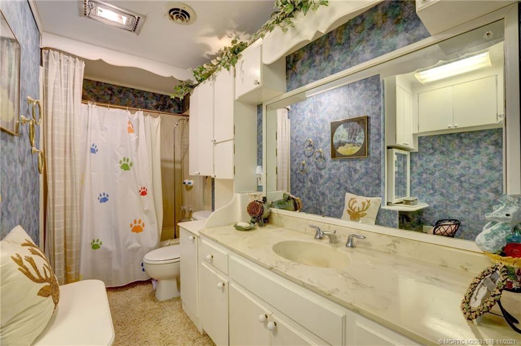 2 Timor Street Sewall's Point, FL 34996 - Photo 31 of 58 a bathroom with a double vanity sink mirror and toilet