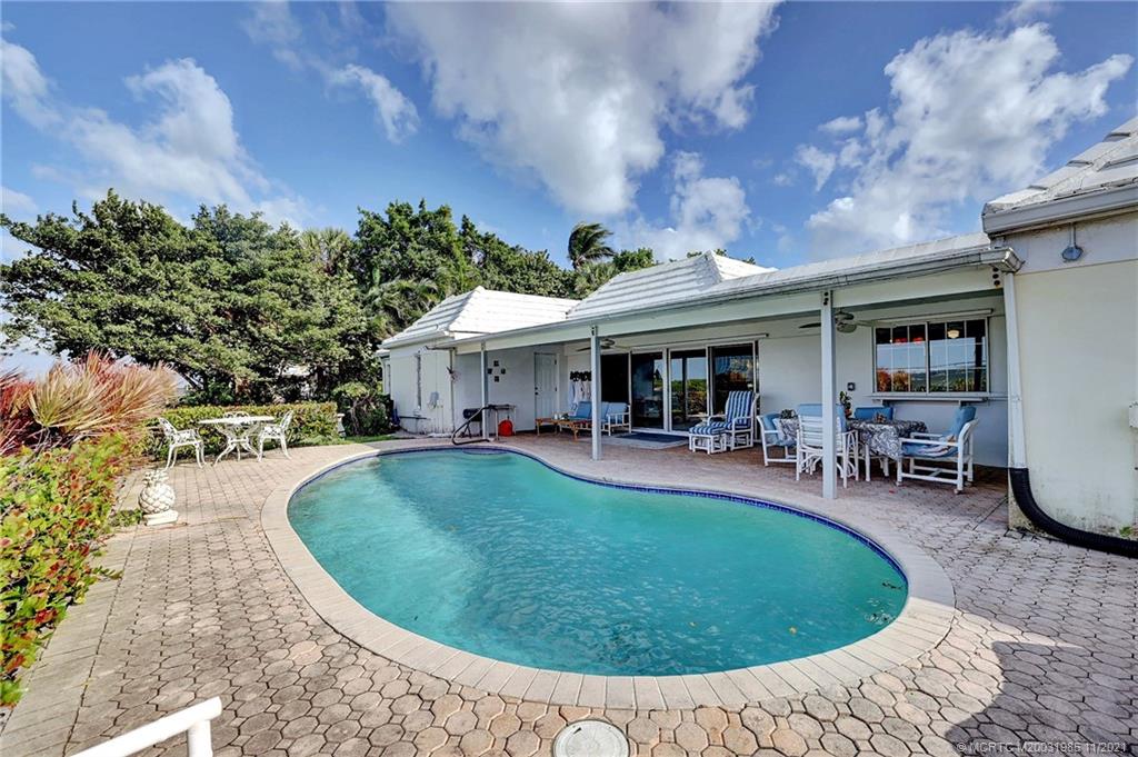 2 Timor Street Sewall's Point, FL 34996 - Photo 41 of 58 a view of a house with swimming pool and sitting area
