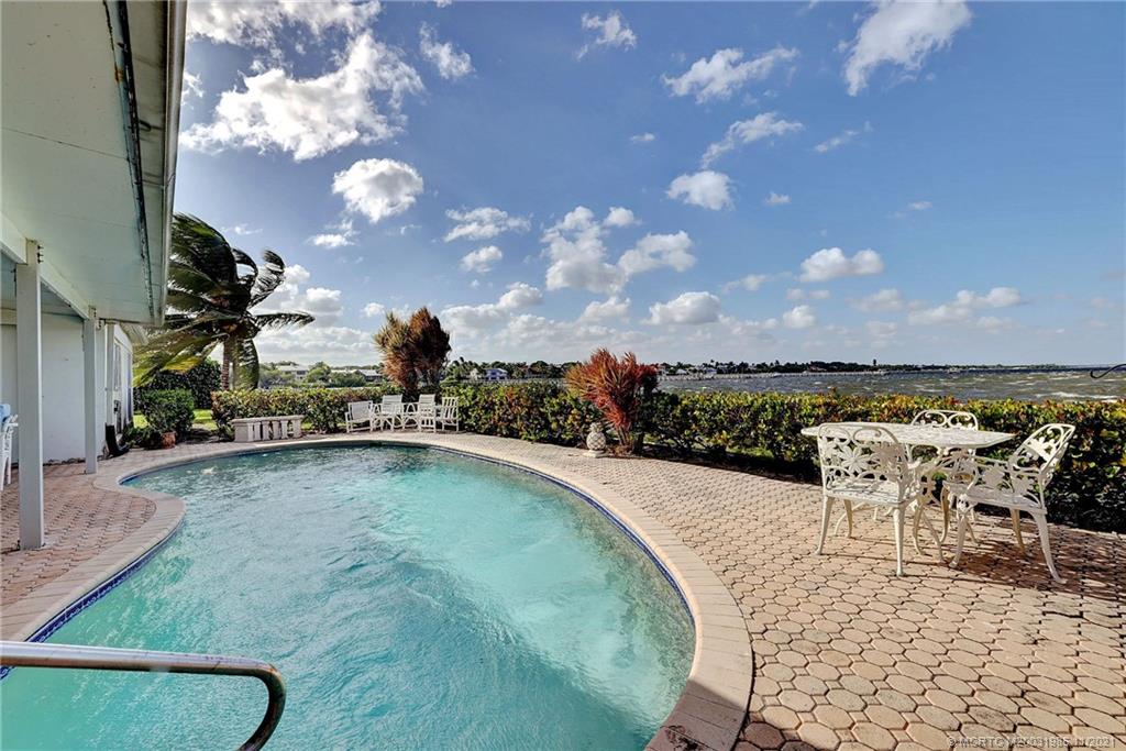 2 Timor Street Sewall's Point, FL 34996 - Photo 42 of 58 a view of a swimming pool with an outdoor seating