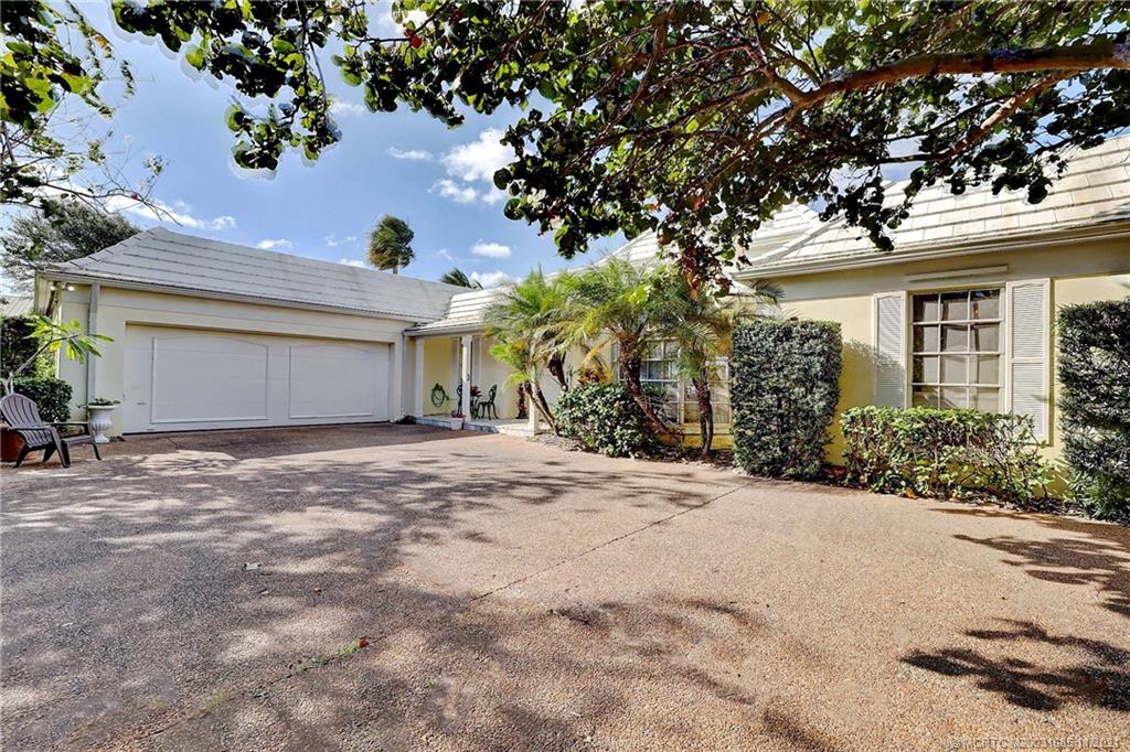 2 Timor Street Sewall's Point, FL 34996 - Photo 5 of 58 a front view of a house with garden