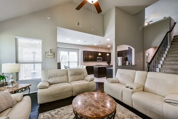 a kitchen with granite countertop a sink a stove and cabinets