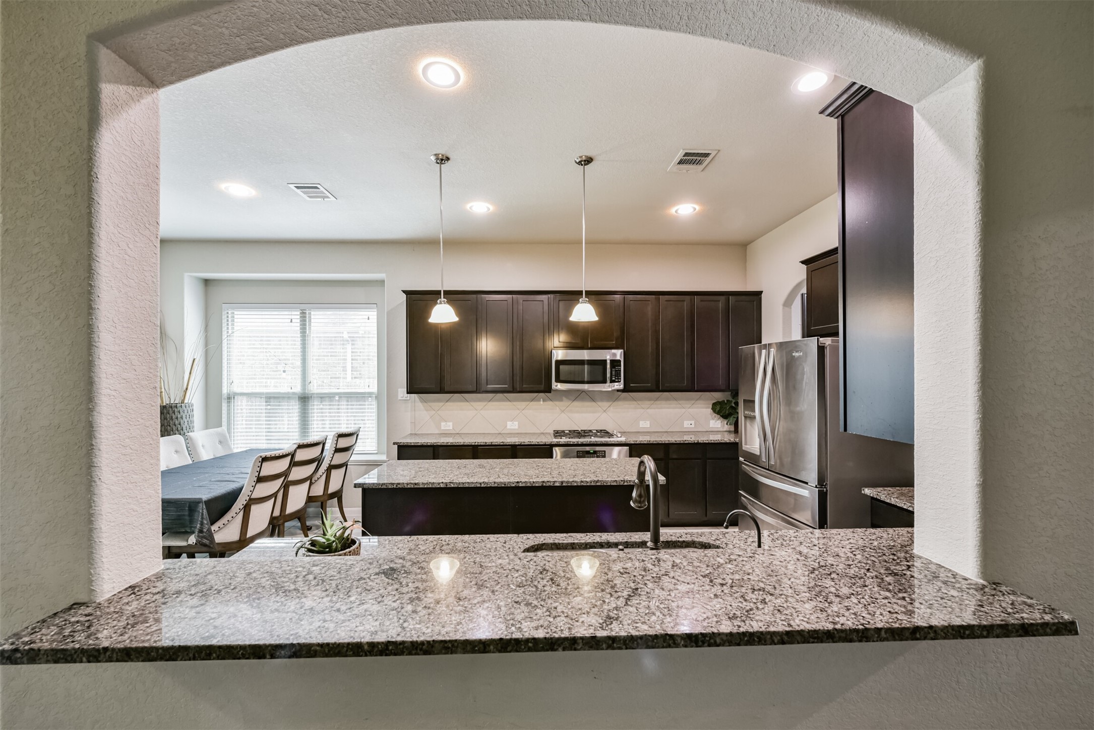 4827 Oak Rambling Drive Katy, TX 77494 - Photo 14 of 45 a view of a kitchen with kitchen island a sink stainless steel appliances and a counter top space