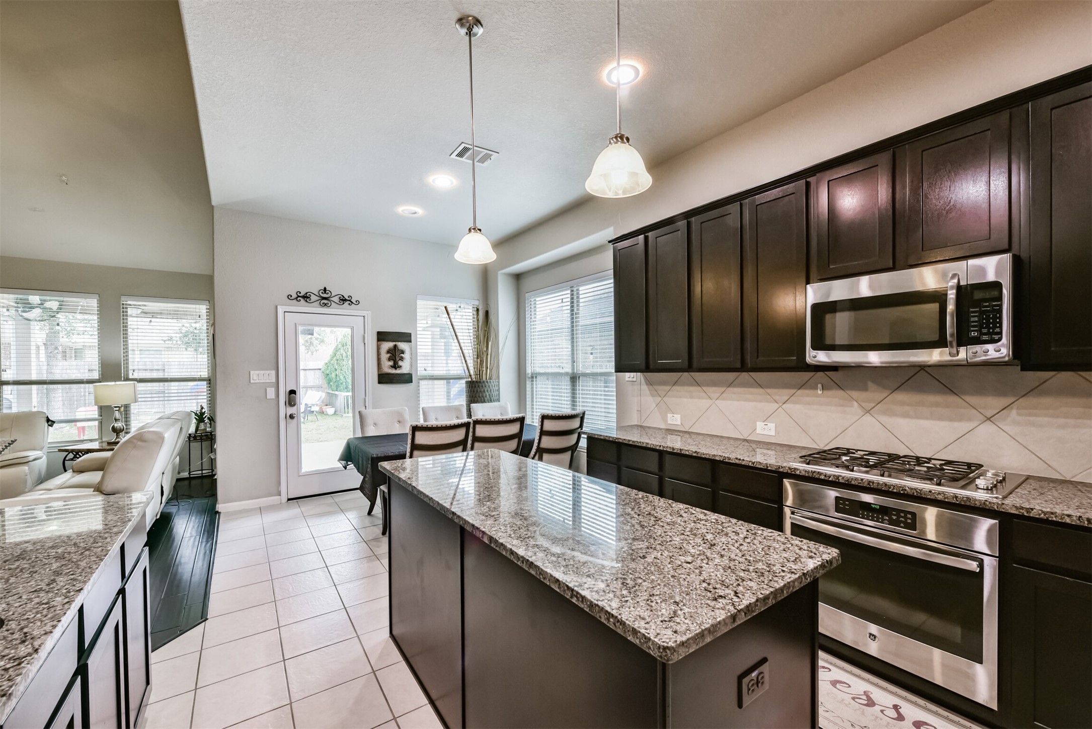 4827 Oak Rambling Drive Katy, TX 77494 - Photo 19 of 45 a large kitchen with granite countertop counter space a sink appliances and cabinets