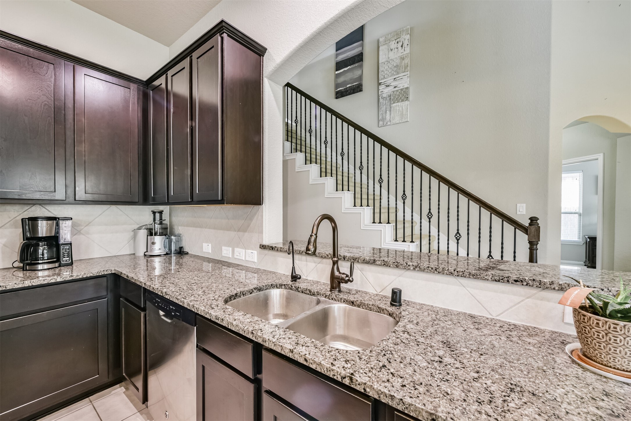 4827 Oak Rambling Drive Katy, TX 77494 - Photo 21 of 45 a kitchen with granite countertop a sink a stove and cabinets