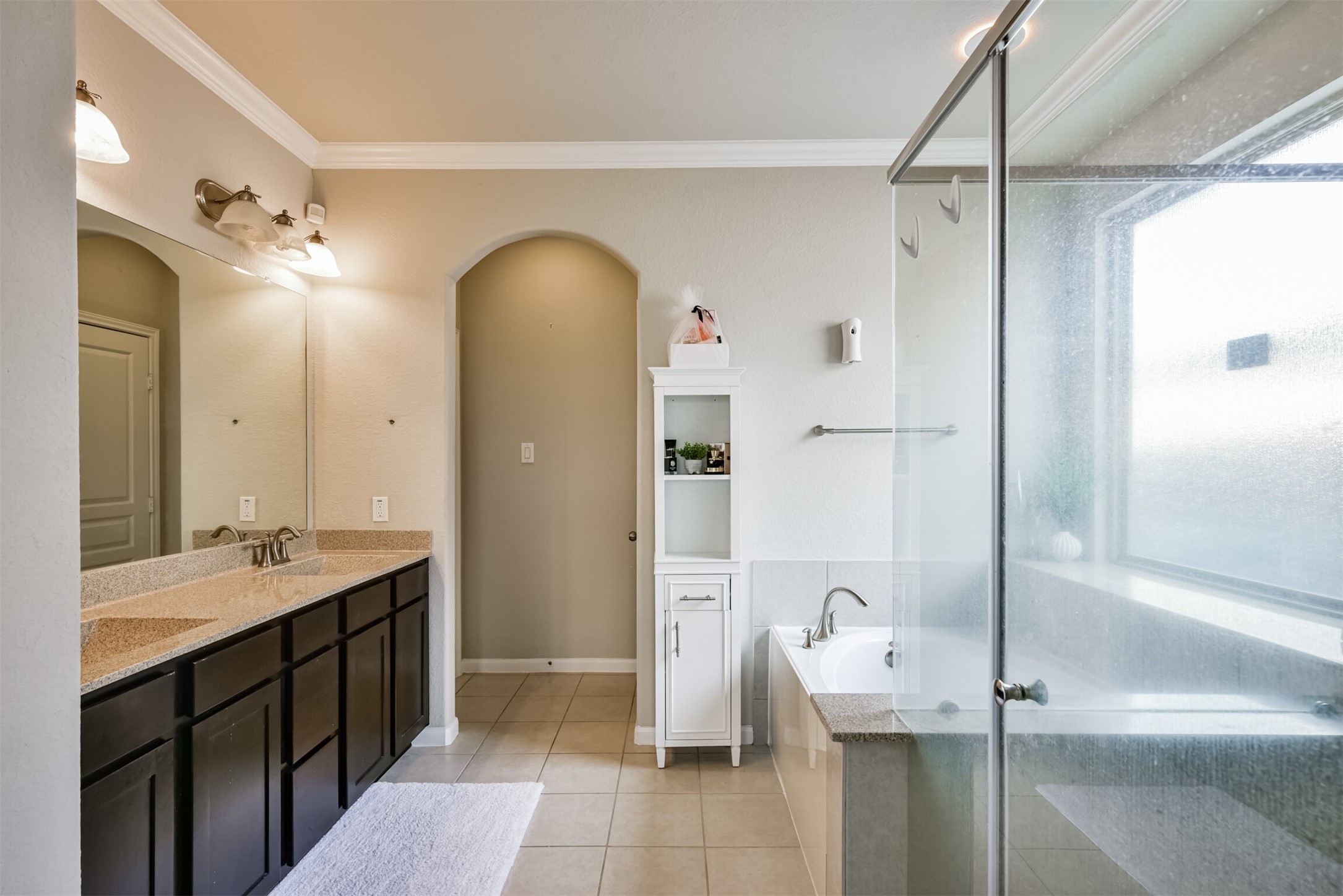 4827 Oak Rambling Drive Katy, TX 77494 - Photo 27 of 45 a bathroom with a double vanity sink a mirror and a shower