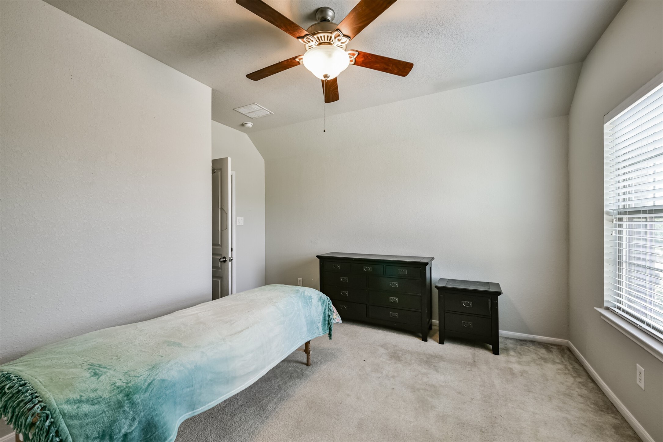 4827 Oak Rambling Drive Katy, TX 77494 - Photo 37 of 45 a bedroom with a bed and a ceiling fan