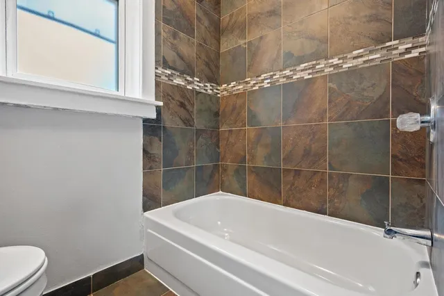a bathroom with a white bathtub