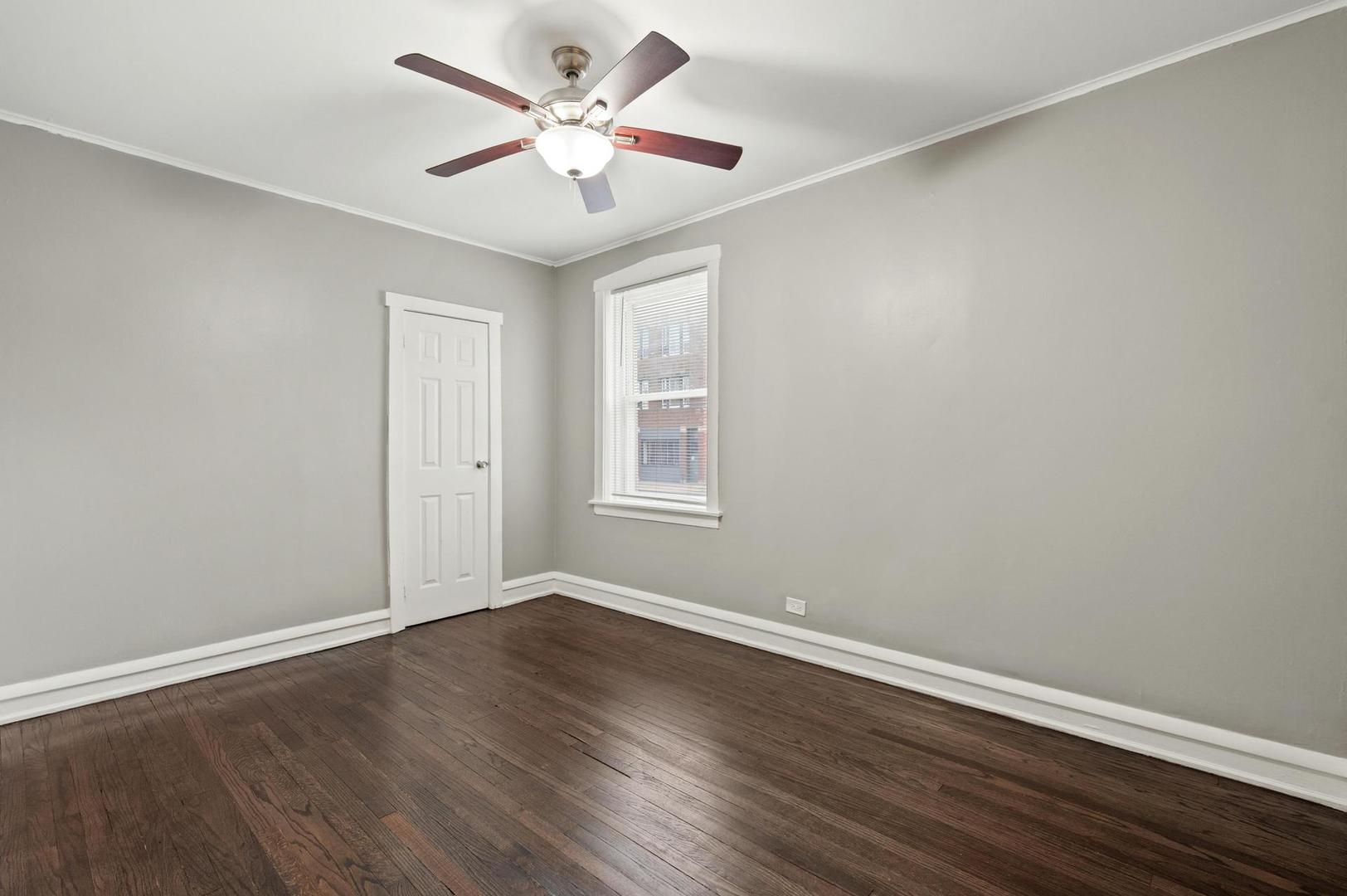 3752 West Division Street, Unit 1E Chicago, IL 60651 - Photo 8 of 11 a view of a big room with wooden floor and windows