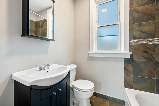 a bathroom with a sink toilet and vanity