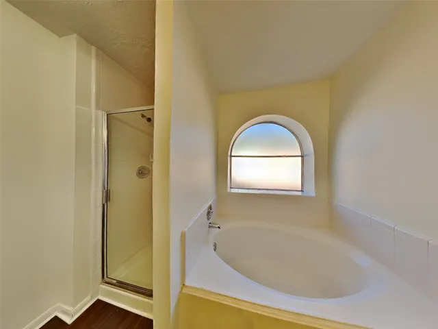 a bathroom with a bathtub and shower