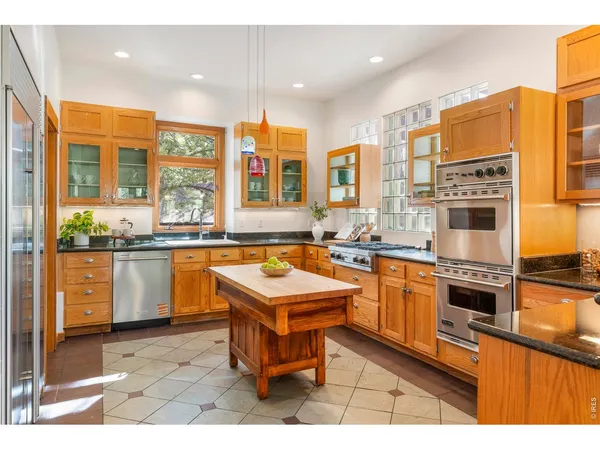 a kitchen with stainless steel appliances granite countertop a sink and cabinets