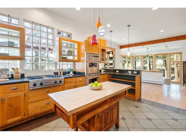 a kitchen with a sink a counter top space and stainless steel appliances