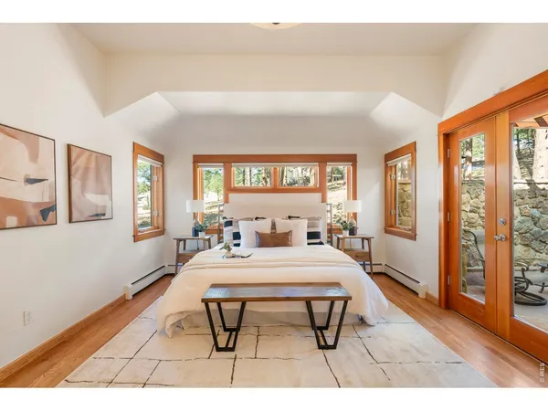 a bed room with a bed and a large window