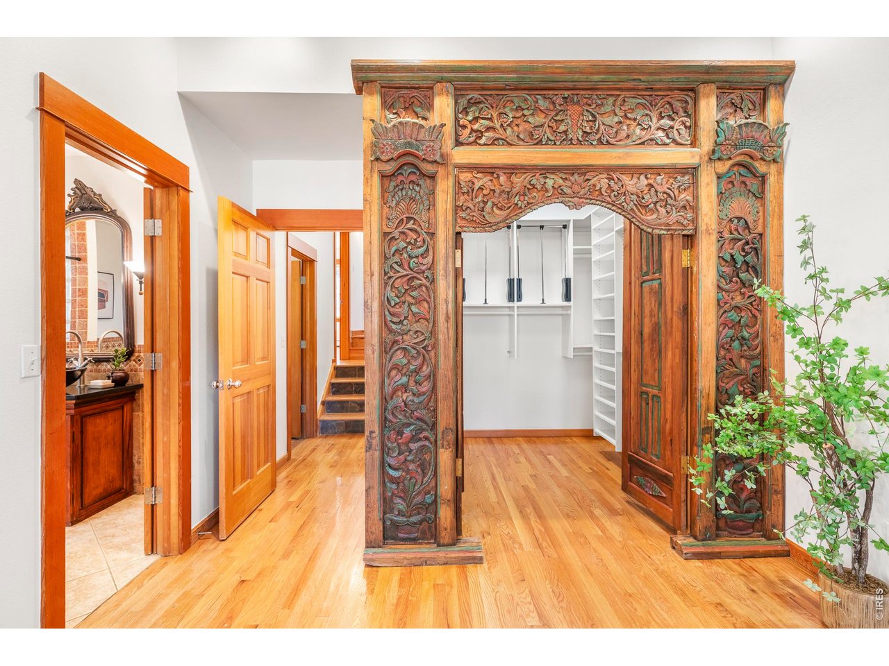 121 Leonards Road Boulder, CO 80302 - Photo 17 of 44 a view of a hallway with wooden floor and a living room