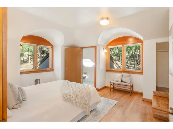 a bedroom with a bed and a large window