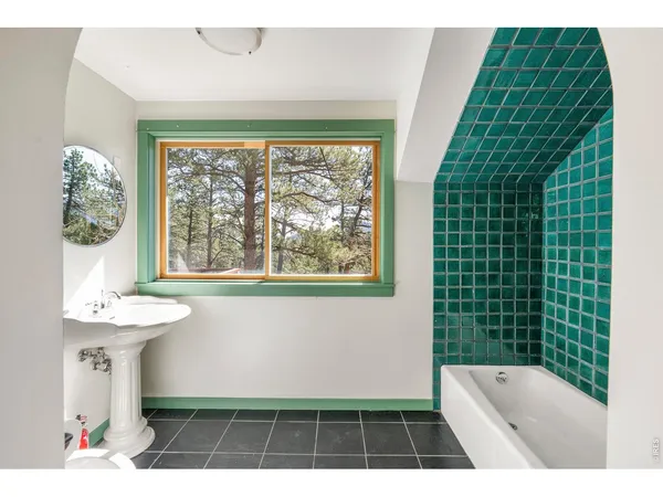 a bathroom with a sink a toilet and window