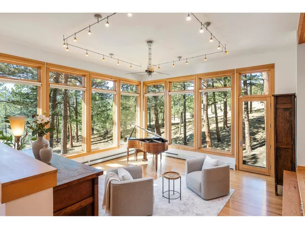 a living room with furniture and large windows